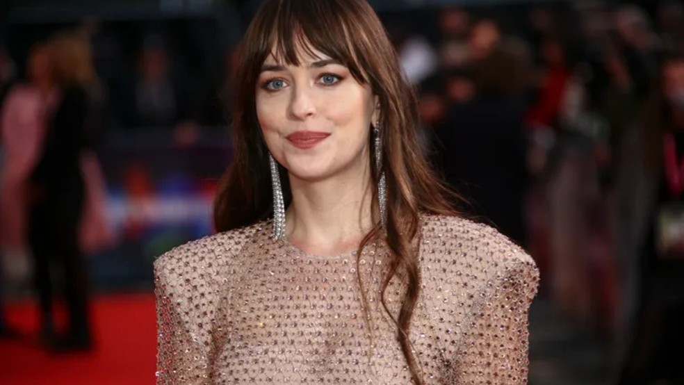 Dakota Johnson é conhecida por ser protagonista da franquia de Cinquenta Tons de Cinza, mas para além disso é do signo de Serpente no Horóscopo Chinês — Foto: Reprodução/Joel C Ryan/Invision/AP, Fil